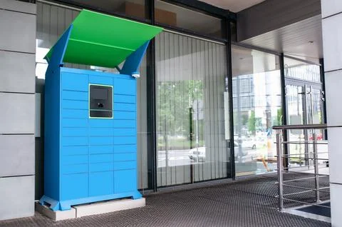Parcel locker with many postal boxes near building outdoors Stock Photos