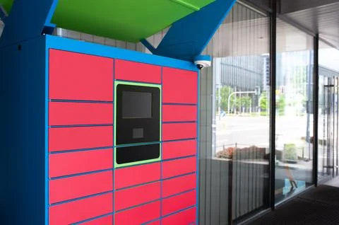 Parcel locker with many postal boxes near building outdoors Stock Photos