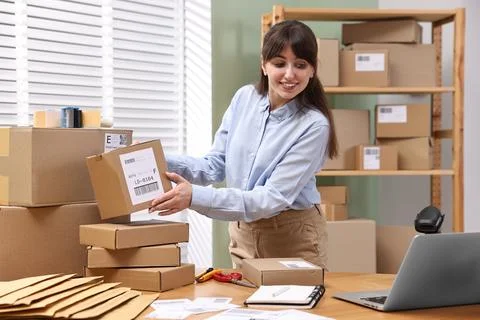 Parcel packing. Post office with parcels at wooden table indoors Stockfoto's