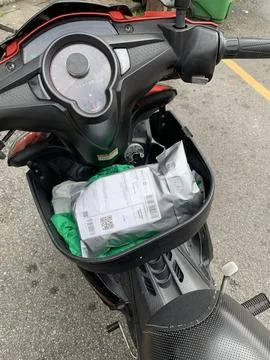A parcel is seen in the motorcycle box, Stock Photos