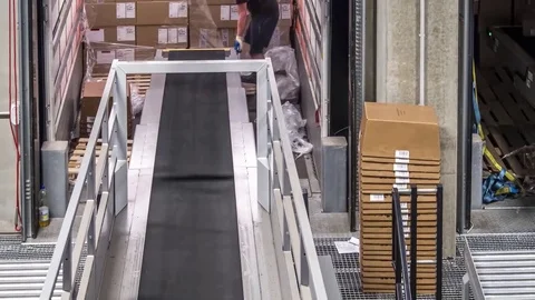 Parcel trailer unloading to conveyor belts Stock Footage 82899680