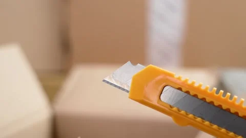 Parcel warehouse with cardboard boxes and stationery knife Stock Footage 263055896