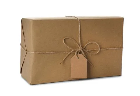 Parcel wrapped in kraft paper with empty label on white background Stock Photos