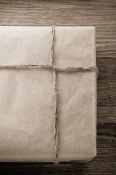 Parcel wrapped packaged box on wood Stock Photos