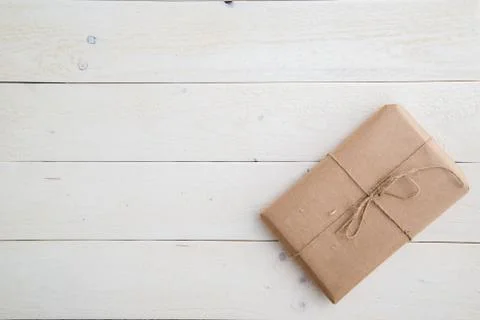 Parcel,gift Packed in eco-friendly paper on light wooden background. the view Stock Photos