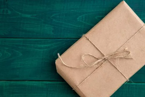 Parcel,gift Packed in eco-friendly paper on dark green wooden background. the Stock Photos