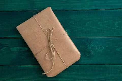 Parcel,gift Packed in eco-friendly paper on dark green wooden background. the Stock Photos