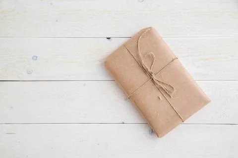 Parcel,gift Packed in eco-friendly paper on light wooden background. the v... 스톡 사진