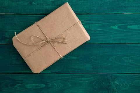Parcel,gift Packed in eco-friendly paper on dark green wooden background. ... 스톡 사진