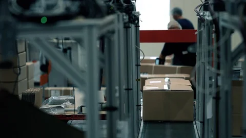 Parcels are picked up by operators on the packaging line in a warehouse. Parcels 스톡 동영상 128295609