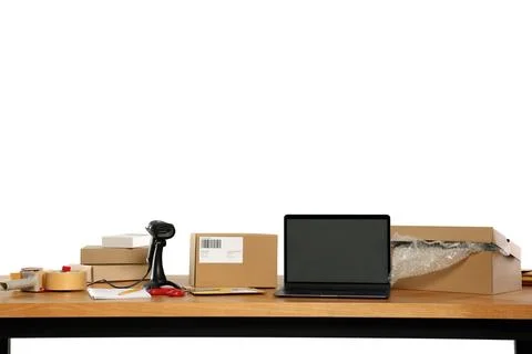 Parcels, laptop and barcode scanner on wooden table against white backgroun.. Stock-Fotos