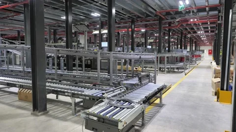 Parcels move on conveyor belt in empty automated sorting center Stock Footage 226289659