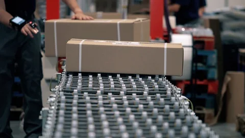 Parcels  on the packaging line in a warehouse. Parcels wait on the conveyor to b Video stock 128295188
