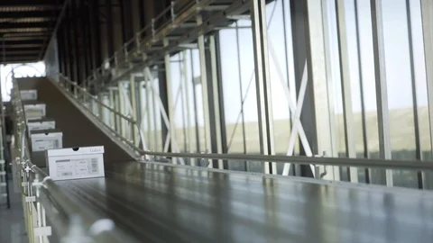 Parcels / shoes boxes are Moving on Belt Conveyor in a warehouse. Video stock 93667153