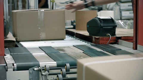 Parcels in a warehouse with cardboard box moving along the packaging line. Plast Stock Footage 128294694
