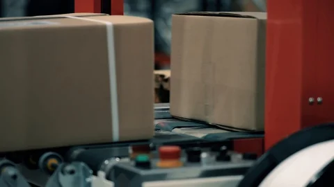 Parcels in a warehouse with cardboard box moving along the packaging line. Plast Stock Footage 128295396
