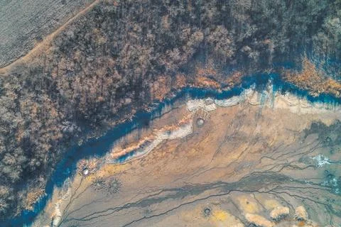 Parched riverbed patterns and cracked mud texture, global warming impact on Stock Photos