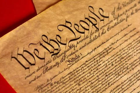 A parchment of the Constitution with a red background Stock Photos