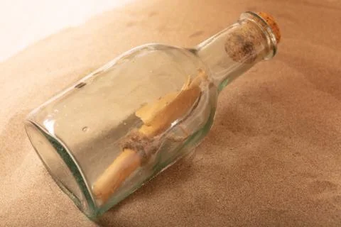 Parchment message in a bottle on the beach Stock Photos