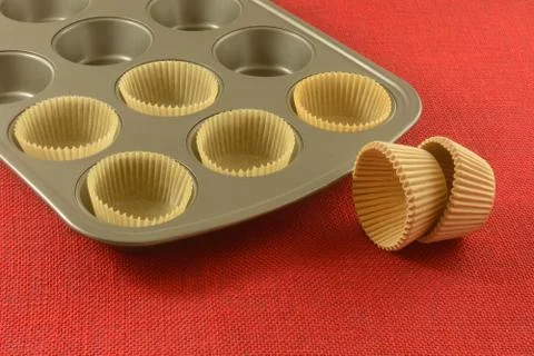 Parchment paper muffin cups in pan Stock Photos