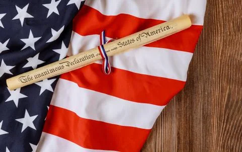 Parchment roll document with US flag on wooden background. Stock Photos
