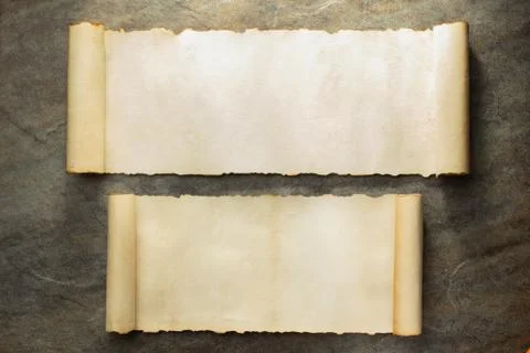 Parchment scroll on stone wall Stock Photos