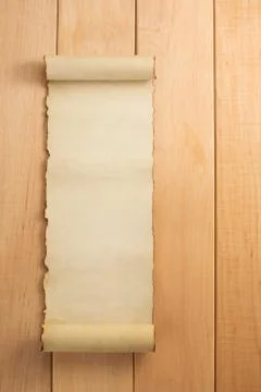 Parchment scroll on wood Stock Photos