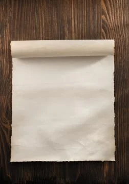 Parchment scroll on wood Stock Photos