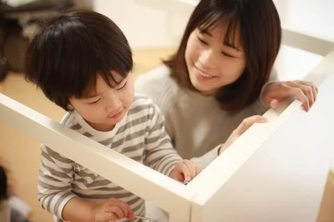 Parent and child assembling a table Stock Photos