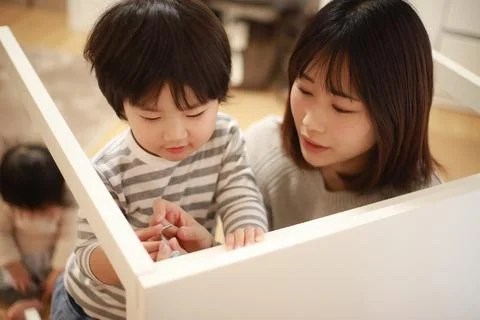 Parent and child assembling a table Stock Photos