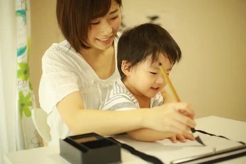 Parent and child doing calligraphy Stock Photos