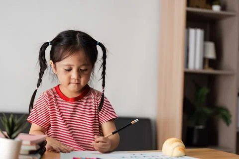 Parent and Child Engaged in Learning Activity at Home, Fostering Education and Stock Photos