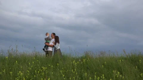 Parent and child stand on spring hill, mother and child play hide and seek  Video stock 46206709