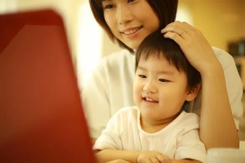Parent and child using a computer Stock Photos
