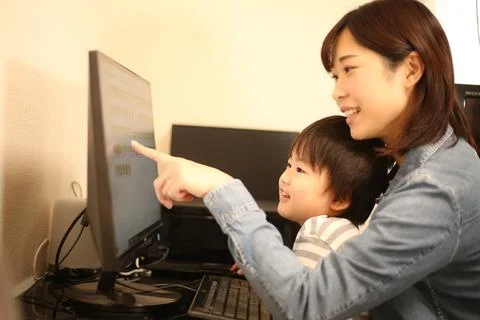 Parent and child using a computer Stock Photos