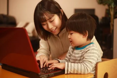 Parent and child using a computer Stock Photos