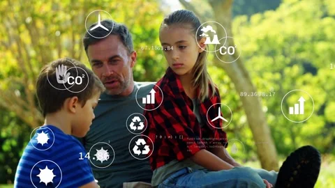 Parent and two children on grass, icons appearing, parent leaning explaining CO2 Stock Footage 332577825