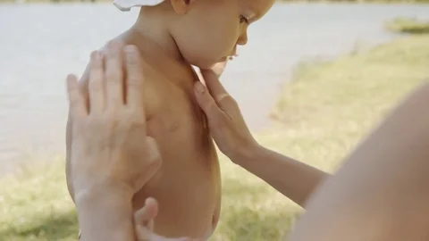 Parent applying cream on child Stock Footage