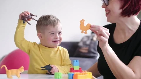 Parent bonding with their child with Down syndrome through an educational and Stock Footage 238861024
