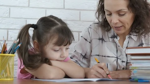Parent helps the child to do homework. Stock Footage 102526627