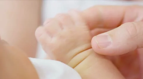 Parent holding newborns hand Stock Footage