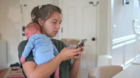 Parent juggles work and home, caring mother effectively manages employment Stock Footage 323092053