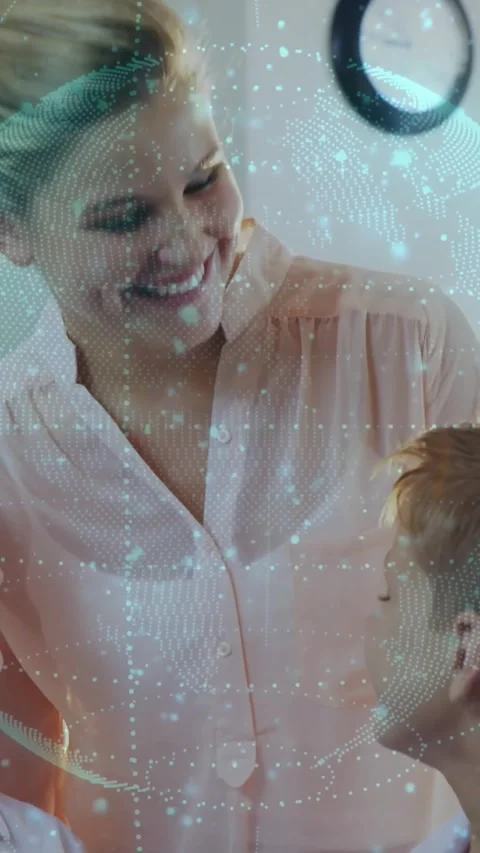 Parent leaning in, speaking to boy looking up for education with globe overlay Stock Footage 330333100