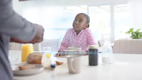 Parent preparing breakfast at table, with animated rings pulsing, youth female Stock Footage 333351683