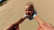 Parent Spinning Daughter By Hands On Beach Pov Stock Footage
