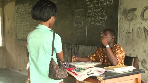 PARENT TALKING TO A TEACHER IN A CLASSROOM Stock Footage 60116018