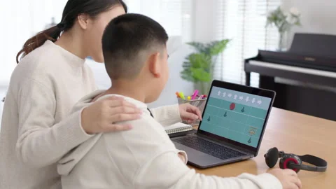 Parent teach unplugged coding for asian kid on computer laptop. Stock Footage 152915998