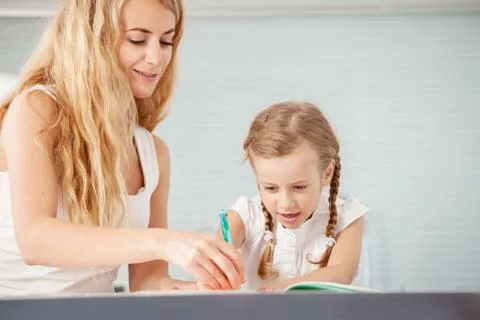 Parent teaches a child to write Stock Photos