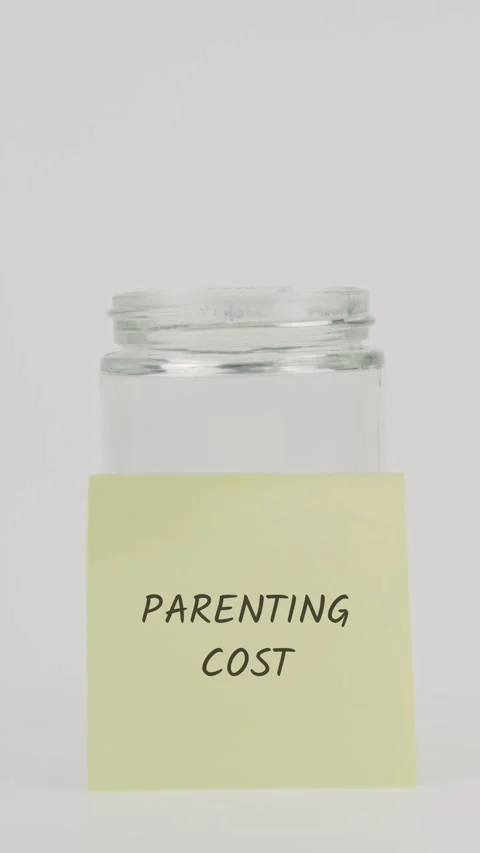 Parenting cost text or word on yellow sticky note attached to glass jar Stock Footage 311762727
