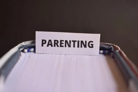 Parenting Paper Tab Between Book Pages Symbolizing Nurturing, Responsibilit.. Fotos de archivo